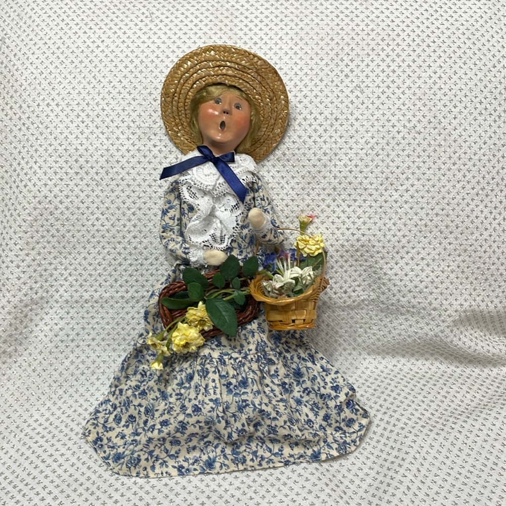 Byers Choice Ltd.  The Carolers doll with baskets of flowers. 2005.